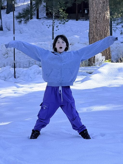 Colette doing a star pose in the snow